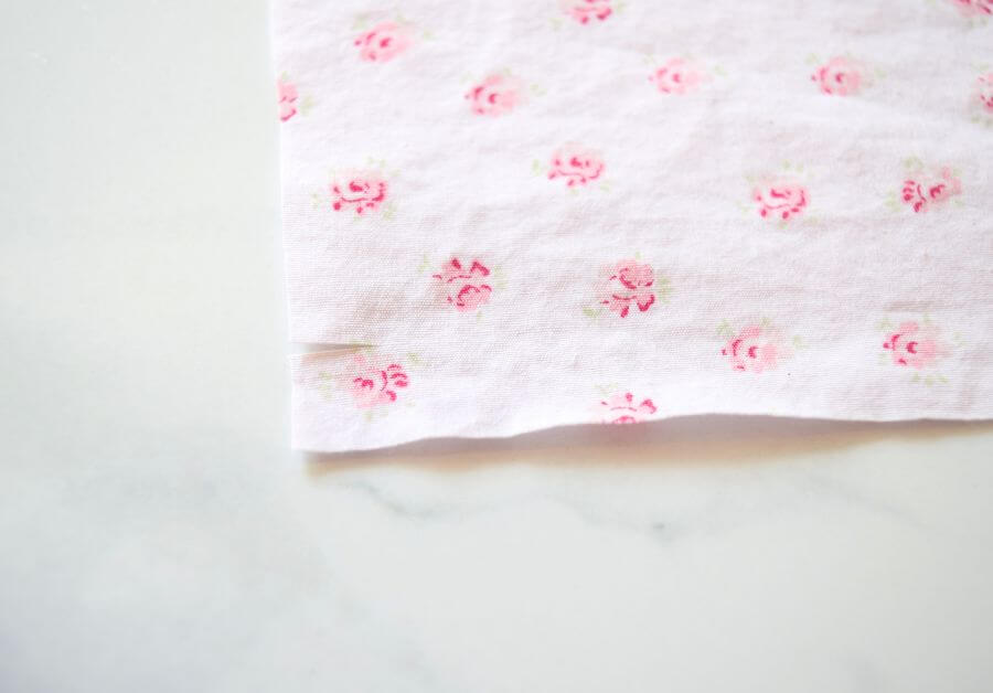 a small cut on the edge of pink floral fabric
