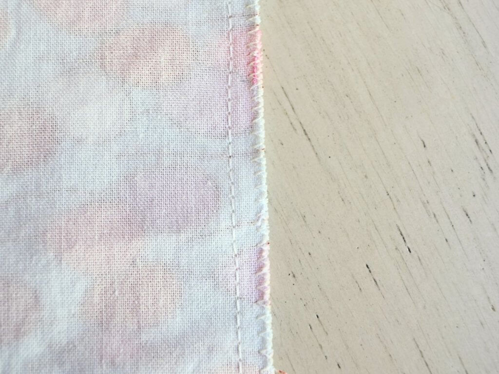 a close up of fabric with a seam and a zigzag stitch on the edge