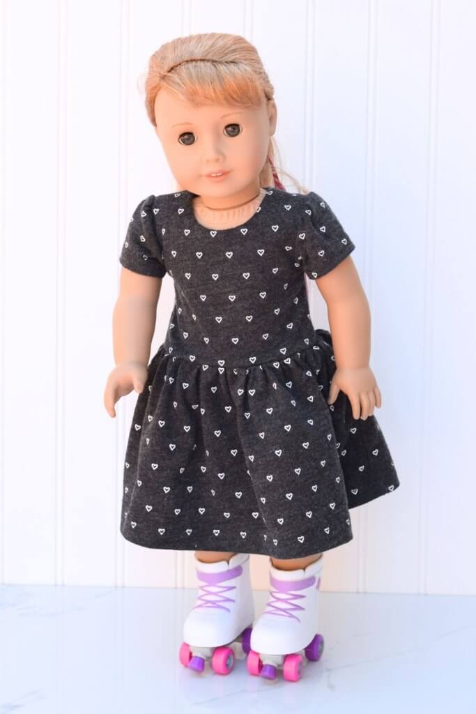 Doll wearing a dress with hearts and roller skates